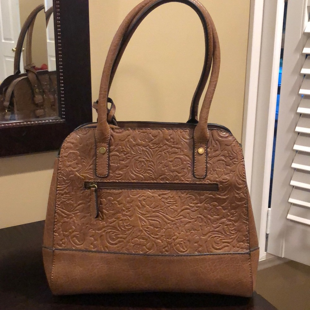 Tan handbag with shoulder strap also